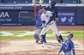  ?? Kathy Willens / Associated Press ?? Toronto Blue Jays catcher Alejandro Kirk points to a fly ball hit by New York Yankee Aaron Judge, who went 0-for-4 in the defeat.