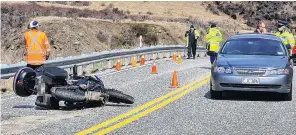  ?? PHOTO: MARJORIE COOK ?? Life lost . . . Emergency services attend a fatal motorbike accident on the Crown Range Rd near Cardrona Village yesterday.