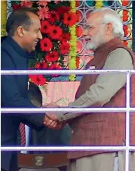  ?? PTI ?? Prime Minister Narendra Modi greets the newly sworn-in Chief Minister of Himachal Pradesh, Jairam Thaku, after the oath ceremony at Ridge in Shimla on Wednesday. —