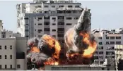  ?? MAHMUD HAMS AP ?? A ball of fire erupts from a building housing various internatio­nal media, including The Associated Press, after an Israeli airstrike on Saturday in Gaza City.