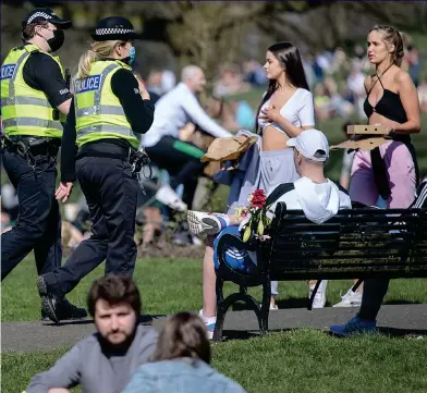  ??  ?? Keeping watch: Police officers amid the crowds at Glasgow’s Kelvingrov­e Park yesterday