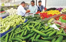  ?? Gulf News archives ?? Residents pick vegetables in a store in Abu Dhabi.