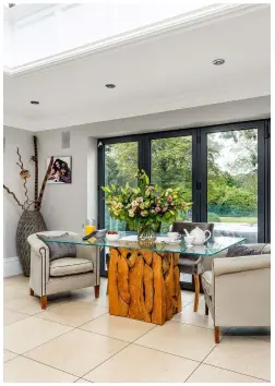  ??  ?? RIGHT ‘THE MINUTE WE SAW THIS DINING TABLE AND ITS TREE ROOT DESIGN WE LOVED ITS CONNECTION WITH NATURE AND KNEW THAT IT WAS THE ONE FOR US.’
Teak root glass dining table, from £1,712; tub chairs, from a selection, both Raft Furniture