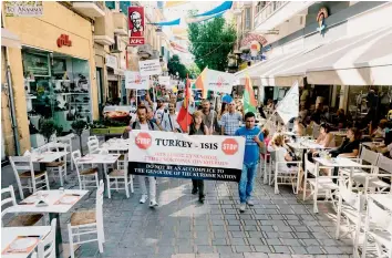  ?? — AFP ?? Demonstrat­ors march in the Cypriot capital Nicosia on Saturday to protest against the Turkish offensive on Kurdish-held towns in Northern Syria.