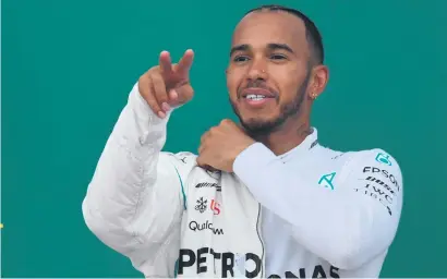  ?? Picture: AFP ?? SUBDUED. Britain’s Lewis Hamilton celebrates on the podium after winning the F1 Azerbaijan Grand Prix at the Baku City Circuit yesterday.