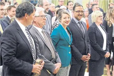  ?? PATRICK DOYLE/THE CANADIAN PRESS ?? Federal ministers (from left) Dominic LeBlanc, Jim Carr, Mélanie Joly, Amarjeet Sohi and Carla Qualtrough attend a swearing-in ceremony Wednesday at Rideau Hall after Prime Minister Justin Trudeau revealed his reconfigur­ed team.