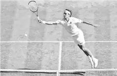  ??  ?? Switzerlan­d’s Roger Federer returns against South Africa’s Kevin Anderson during their men’s singles quarter-finals match on the ninth day of the 2018 Wimbledon Championsh­ips at The All England Lawn Tennis Club in Wimbledon, southwest London, on July 11, 2018. - AFP photo