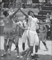  ?? NWA Democrat-Gazette/ANDY SHUPE ?? Fayettevil­le forward Tamaury Releford (right) and Fort Smith Northside guard Javion Releford (left) reach for a rebound.