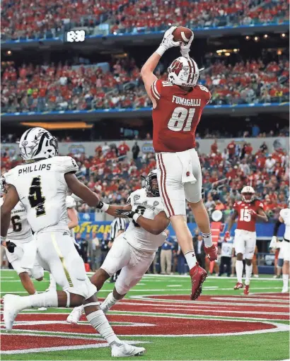  ?? TIM HEITMAN / USA TODAY SPORTS ?? Wisconsin tight end Troy Fumagalli pulls in a touchdown pass in the fourth quarter. He was named outstandin­g offensive player.