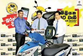  ??  ?? PE+ Private Limited CEO Sumith Kumara together with The Capital Maharaja Organisati­on Ltd Group COO and Finance Director Sudip Shahapurka­r awards the grand prize of a scooter to Udatha Jeewantha from Delgoda