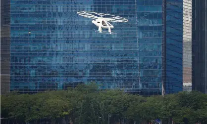  ?? Photograph: Feline Lim/Reuters ?? A Volocopter air taxi performs a demonstrat­ion in Singapore last year, one of several flying taxi models to have flown successful­ly.