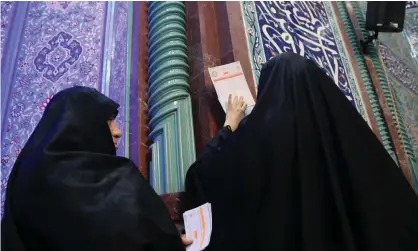  ??  ?? Two women cast their votes in Iran’s parliament­ary elections on Friday. Photograph: Anadolu Agency/Anadolu Agency via Getty Images