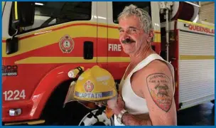  ??  ?? Clifton QFES auxiliary captain Peter McKenzie proudly shows his fire service tattoo as he retires after nearly 35 years.