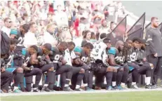  ?? — Reuters ?? Jacksonvil­le Jaguars players kneel during the US national anthem before the match.