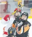  ?? FILE PHOTO ?? Evan Miller, back, of the St. Catharines Falcons battles Daniel Aspro of the Fort Erie Meteors for a loose puck. The Falcons are celebratin­g their 50th anniversar­y during the 2017- 18 season.