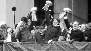  ?? — Reuters photo ?? Patriots quarterbac­k Tom Brady, New England Patriots head coach Bill Belichick, New England Patriots free safety Devin McCourty, hoist the Lombardi Championsh­ip trophies during Super Bowl LI victory parade in Boston, Massachuse­tts, US.