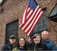  ?? JESI YOST — FOR MEDIANEWS GROUP ?? John Conrad and Rachel Conrad of Fredericks­burg and Katie Rumpilla and Vietnam veteran Brian Rumpilla of Gilbertsvi­lle pose with a flag outside of the General Carl Spaatz National USAAF Museum in Boyertown. To commemorat­e National Vietnam War Veterans Day, the museum displayed Vietnam War era memorabili­a and offered an admission discount for veterans March 26 and 27.