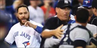  ?? FRANK GUNN, THE CANADIAN PRESS ?? Russell Martin trades words with New York catcher Gary Sanchez during a bench-clearing melee after Yankees pitcher Luis Severino hit Blue Jays’ Justin Smoak with a pitch in the second inning in Toronto on Monday night.