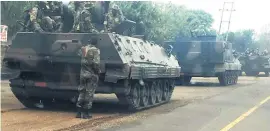  ??  ?? TENSE. Army vehicles heading towards Harare yesterday, heightenin­g fears of a possible army take over.
