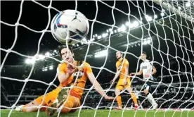  ?? Photograph: Tim Goode/PA ?? Hull's Alfie Jones (left) fails to stop Tom Lawrence's shot from finding the net in Derby’s victory.