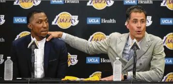  ?? JAE C. HONG / ASSOCIATED PRESS ?? General manager Rob Pelinka introduces a new free-agent arrival, former Detroit starter Kentavious Caldwell-Pope, this week as the Lakers try to bounce back from the worst four-year stretch in club history.