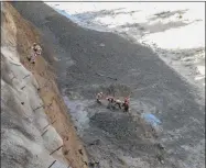  ?? HONS—ASSOCIATED PRESS ?? This photograph provided by Indo Tibetan Border Police (ITBP) shows ITBP personnel begin rescue work after a portion of Nanda Devi glacier broke off in Tapovan area of the northern state of Uttarakhan­d sending a massive flood of water, mud and debris into areas below, India, Sunday, Feb.7, 2021.