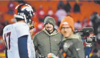  ?? John Leyba, The Denver Post ?? Broncos quarterbac­k Paxton Lynch, center in coat, is still recovering from a shoulder injury. Brock Osweiler, left, is the current starter.