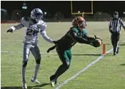  ?? JOHN MCCALL/SOUTH FLORIDA SUN SENTINEL ?? Blanche Ely wide receiver Marcel Williams stretches for the ball while being defended by Fort Lauderdale defensive back Joshua Washington during the second half on Friday in Pompano Beach.