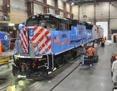  ?? Mark Llanuza ?? Wearing the paint scheme of the predecesso­r Regional Transporta­tion Authority, Metra’s first SD70MACH is unwrapped on delivery at BNSF’s 14th Street Shops on Oct. 11, 2022.