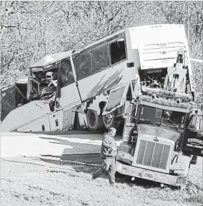  ?? JOSH BRIGGS THE ASSOCIATED PRESS ?? The bus was carrying a youth football team from Tennessee when it rolled off an interstate off-ramp and overturned before sunrise Monday. The elementary-school age football team from Orange Mound Youth Associatio­n in southeast Memphis had played in a tournament in Dallas over the weekend.