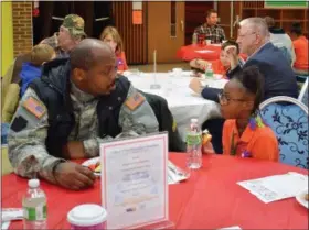  ?? BRIANA CONTRERAS — THE MORNING JOURNAL ?? Neveah Scott, a third-grader at Horizon Science Academy, eats breakfast with Army veteran Evangel Coleman for the school’s Veterans Day celebratio­n Nov. 10.