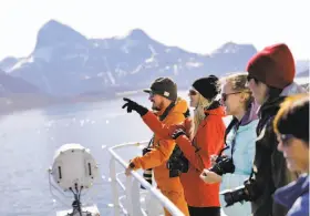  ?? David Goldman / Associated Press ?? Researcher­s look out from the Finnish icebreaker MSV Nordica as it arrives at Nuuk, Greenland, after traversing the Northwest Passage.