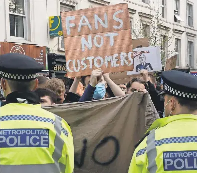  ??  ?? Chelsea fans protest outside Stamford Bridge stadium in London against the English Premier League team’s decision to be included among soccer clubs attempting to form a new European Super League. AP
