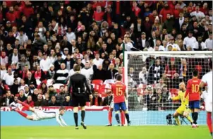  ?? JUSTIN TALLIS/AFP ?? England striker Jamie Vardy (left) scores against Spain with a diving header in their friendly at Wembley Stadium, northwest London, on Tuesday night.