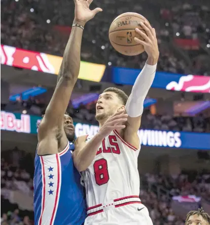  ?? CHRIS SZAGOLA/AP ?? Guard Zach LaVine, putting up a shot against 76ers center Joel Embiid, led the Bulls with 30 points Thursday night.