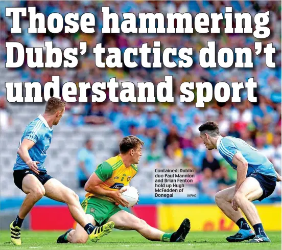  ?? INPHO ?? Contained: Dublin duo Paul Mannion and Brian Fenton hold up Hugh McFadden of Donegal