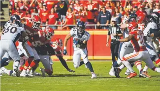  ?? Andy Cross, The Denver Post ?? Broncos running back Devontae Booker finds a hole in the Kansas City defense in the first quarter at Arrowhead Stadium on Sunday.