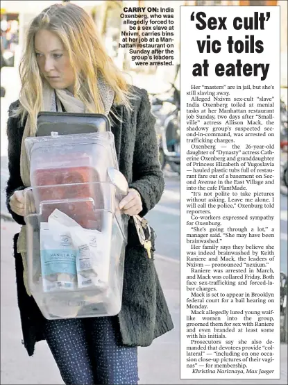  ??  ?? CARRY ON: India Oxenberg, who was allegedly forced to be a sex slave at Nxivm, carries bins at her job at a Manhattan restaurant on Sunday after the group’s leaders were arrested.