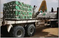  ?? AP/JON GAMBRELL ?? Relief workers in February unload aid in Marib, Yemen, that was carried into the country by the Saudi military.