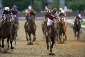  ?? CHARLIE NEIBERGALL - THE ASSOCIATED PRESS ?? Sonny Leon celebrates after riding Rich Strike past the finish line to win the 148th running of the Kentucky Derby horse race at Churchill Downs Saturday, May 7, 2022, in Louisville, Ky.