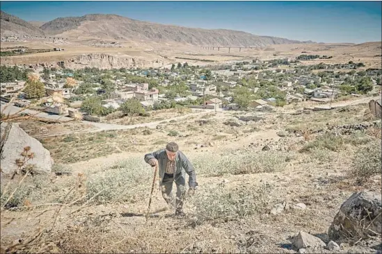  ?? Photograph­s by Kiran Ridley For The Times ?? SHEPHERD Ramazan Agalday, 80, climbs to the caves above the town, many of which were carved by Neolithic settlers. Agalday does not know where he’ll go now.