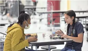  ?? MICHAEL HOLAHAN/USA TODAY NETWORK ?? Students eat lunch at Grovetown Middle School near Augusta, Ga., in 2020.