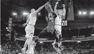  ?? David J. Phillip, The Associated Press ?? The Nuggets’ Nikola Jokic, left, and Torrey Craig defend Russell Westbrook as the Houston Rockets guard goes up for a shot on Wednesday night.