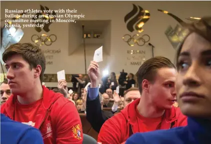  ??  ?? Russian athletes vote with their ballots during an Russian Olympic committee meeting in Moscow, Russia, yesterday