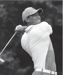  ?? KEVIN C. COX/GETTY IMAGES ?? Tiger Woods tees off during the first round of the Wyndham Championsh­ip on Thursday in Greensboro, N.C.