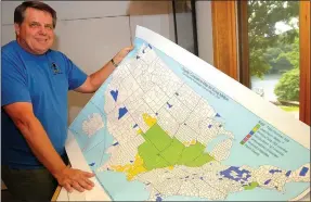  ?? NWA Democrat-Gazette/FLIP PUTTHOFF ?? Doug Melton of Bella Vista keeps detailed informatio­n about his adventures hiking to the highest point in several states and hundreds of counties. On May 20 he shows a map that indicates he has hiked to the highest point of every county in seven states...