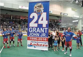  ?? CLIFFORD SKARSTEDT/EXAMINER FILE PHOTO ?? A banner is raised to the rafters as lacrosse player John Grant Jr.’s number is retired by the Lakers at the Memorial Centre on Aug. 2, 2016. Don Barrie names Grant as one of Peterborou­gh’s 100 key sports figures.