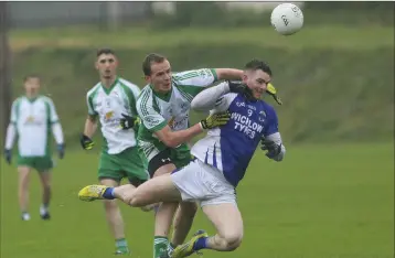  ??  ?? Baltinglas­s’ Jason Kennedy swarms all over St Pat’s EamonWolfe during the Division 1 SFL in Dunbur Park.