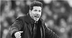  ??  ?? Atletico Madrid’s Argentinia­n coach Diego Simeone gives instructio­ns to his players during the Spanish league football match between Real Betis and Atletico Madrid at the Benito Villamarin Stadium in Sevilla in this Dec 10 file photo. — AFP photo