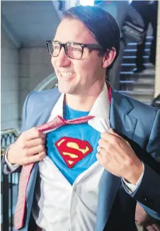  ?? CP ?? Left: Prime Minister Justin Trudeau, dressed as DC Comics character Clark Kent, goes trick-or-treating with son Hadrien, dressed as Paw Patrol character Skye, at Rideau Hall in Ottawa on Tuesday. Right: Trudeau reveals Kent’s super alter ego on...
